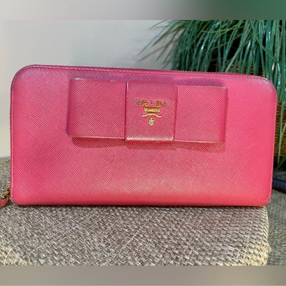 Prada Handbags - Prada Pink Zip Around Long Wallet Wallet with Bow Accent and Gold
Hardware